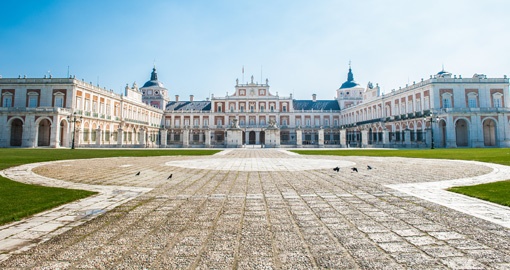 Le palais royal d’Aranjuez et sa grande cour pavée sous un ciel bleu